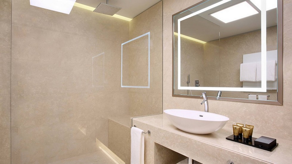 The bathroom continues the opulence with marble tiling, a sleek bath and shower combination, customized lotions, shampoos and conditioners, thick bathrobes and slippers, two vanities and a make-up mirror.