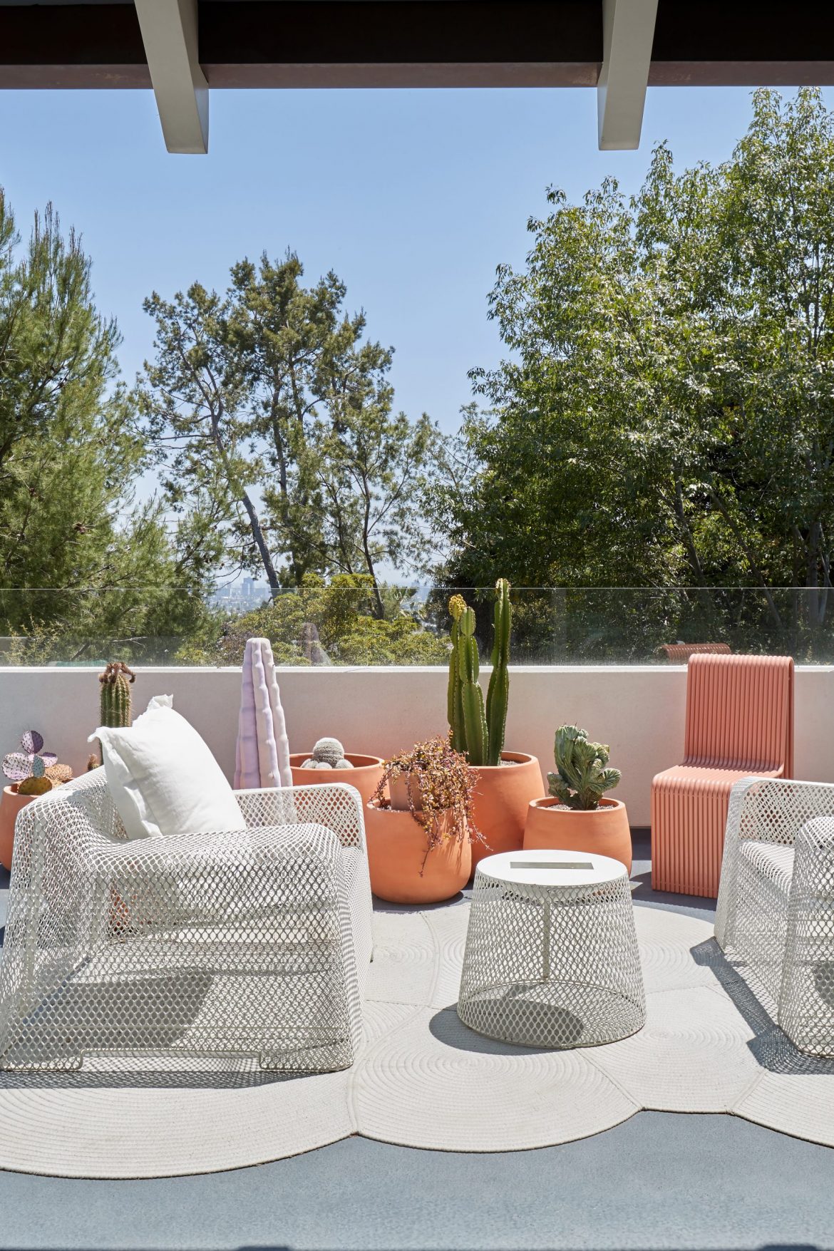 Ghislaine Viñas terrace with white and orange furniture